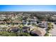 Aerial view of a residential neighborhood with houses and a lake at 5003 Southern Pine Cir, Venice, FL 34293