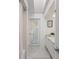 White bathroom with marble floor, a shower, and built in vanity at 5003 Southern Pine Cir, Venice, FL 34293