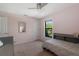 Bedroom with a gray bed, window, and decorative mirror at 5003 Southern Pine Cir, Venice, FL 34293