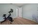 Home gym with Peloton bike and wood flooring at 5003 Southern Pine Cir, Venice, FL 34293