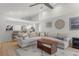 Open-concept living room with a view into the kitchen and light hardwood floors at 5003 Southern Pine Cir, Venice, FL 34293