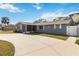 Ranch style home with gray exterior, palm trees, and a long driveway at 5172 Rolla Rd, Venice, FL 34293