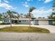 Gray house with palm trees, a driveway, and a two-car garage at 5172 Rolla Rd, Venice, FL 34293