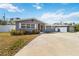 Gray house with a screened porch, driveway, and well-manicured lawn at 5172 Rolla Rd, Venice, FL 34293