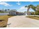 Single-Gathering home with circular driveway and palm trees at 5172 Rolla Rd, Venice, FL 34293