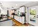 Modern kitchen with white cabinets, granite counters, and pool view at 5172 Rolla Rd, Venice, FL 34293