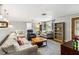 Bright living room with hardwood floors, sofas, and built-in shelving at 5172 Rolla Rd, Venice, FL 34293