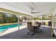 Screened patio with dining table, chairs and a view of the pool at 5172 Rolla Rd, Venice, FL 34293