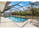 Inviting screened-in pool with lounge chairs and lush landscaping at 5172 Rolla Rd, Venice, FL 34293