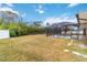 Large backyard with grassy area and screened pool at 5296 Rolla Rd, Venice, FL 34293