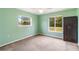 Spacious bedroom with light green walls and carpeting at 5296 Rolla Rd, Venice, FL 34293