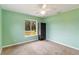 Light green bedroom with carpet, window, and closet at 5296 Rolla Rd, Venice, FL 34293