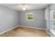 Gray bedroom with carpet, ceiling fan, and window at 5296 Rolla Rd, Venice, FL 34293