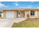 Updated tan house with white garage door at 5296 Rolla Rd, Venice, FL 34293