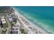 Aerial view of beachfront property, showcasing nearby buildings and ocean at 5298 Drew Rd, Venice, FL 34293