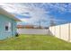 Large backyard with grassy area and white fence at 5298 Drew Rd, Venice, FL 34293