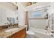 Bathroom with a bathtub, shower, granite countertop and window at 5298 Drew Rd, Venice, FL 34293