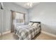 Well-lit bedroom with a full-size bed and plaid comforter at 5298 Drew Rd, Venice, FL 34293