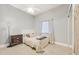 Cozy bedroom with a full-size bed, dresser, and floor lamp at 5298 Drew Rd, Venice, FL 34293