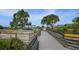 Beach boardwalk with wooden railings, leading to covered seating areas at 5298 Drew Rd, Venice, FL 34293