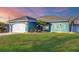 Teal home with white garage door and landscaping at 5298 Drew Rd, Venice, FL 34293