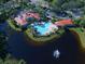 Aerial view of community pool, clubhouse, and lush landscaping at 589 Pond Willow Ln, Venice, FL 34292