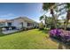 Landscaped backyard with tropical plants at 589 Pond Willow Ln, Venice, FL 34292