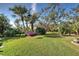 Lush backyard with tropical landscaping at 589 Pond Willow Ln, Venice, FL 34292