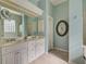 Double vanity, large mirror and tiled floors in Primary bathroom at 589 Pond Willow Ln, Venice, FL 34292