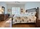 Bedroom with king bed, hardwood floors, and dresser at 589 Pond Willow Ln, Venice, FL 34292