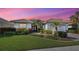 Well-maintained home with lush landscaping at dusk at 589 Pond Willow Ln, Venice, FL 34292