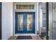 Blue double front doors with glass inserts and sidelights at 589 Pond Willow Ln, Venice, FL 34292