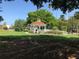 White gazebo with orange roof in a park-like setting at 589 Pond Willow Ln, Venice, FL 34292