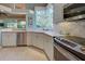 Updated kitchen featuring white cabinets, stainless steel appliances, and a corner sink at 589 Pond Willow Ln, Venice, FL 34292