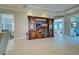 Living room with large entertainment center and views to other rooms at 589 Pond Willow Ln, Venice, FL 34292