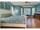 King-size bed, hardwood floors, and large windows in this main bedroom at 589 Pond Willow Ln, Venice, FL 34292