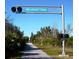 Paved trail entrance to The Legacy Trail, featuring a sign and railroad crossing signals at 589 Pond Willow Ln, Venice, FL 34292