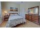 Bedroom with wood floors and wooden dresser at 746 Fringed Orchid Trl, Venice, FL 34293