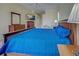 Main bedroom with blue bedding and wood floors at 746 Fringed Orchid Trl, Venice, FL 34293