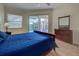 Bedroom with king bed and access to pool view at 746 Fringed Orchid Trl, Venice, FL 34293