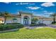 Well-maintained house featuring a large driveway and landscaping at 746 Fringed Orchid Trl, Venice, FL 34293