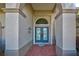 Elegant double doors with arched entryway and brick walkway at 746 Fringed Orchid Trl, Venice, FL 34293