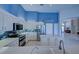 Modern kitchen with white cabinets, stainless steel appliances, and blue accent walls at 746 Fringed Orchid Trl, Venice, FL 34293