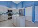 Modern kitchen with stainless steel appliances and blue walls at 746 Fringed Orchid Trl, Venice, FL 34293