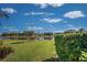 Serene lake view from a beautifully landscaped backyard at 746 Fringed Orchid Trl, Venice, FL 34293