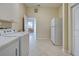 Laundry room with washer, dryer, refrigerator, and access to other areas at 746 Fringed Orchid Trl, Venice, FL 34293