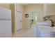 Laundry room with washer, dryer, and additional storage space at 746 Fringed Orchid Trl, Venice, FL 34293