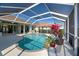 Relaxing screened pool area with a fountain and lush landscaping at 746 Fringed Orchid Trl, Venice, FL 34293