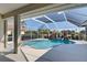 Inviting pool area with screened enclosure, fountain, and lush landscaping at 746 Fringed Orchid Trl, Venice, FL 34293