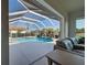 Inviting screened pool with fountain and view from inside the house at 746 Fringed Orchid Trl, Venice, FL 34293